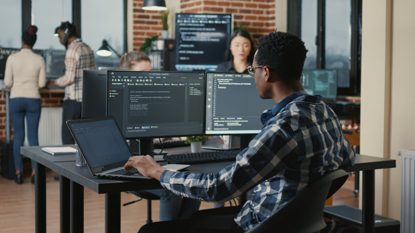 co-workers in an office coding on computers